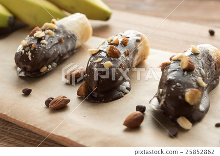 Mini chocolate covered frozen bananas with almonds 25852862