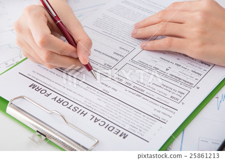 Hands of medical doctor writing on a clipboard Hands of medical doctor writing on a clipboard 25861213