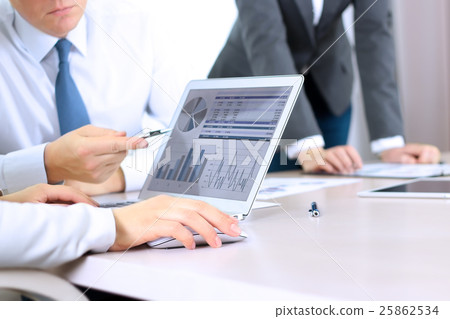 Colleagues working and analyzing financial figures 25862534