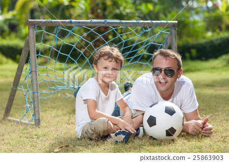 Father and son playing in the park at the day time. Father and son playing in the park at the day time. 25863903