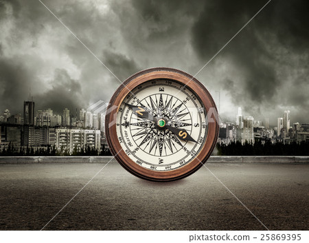 Compass on view of city in stormy sky Compass on view of city in stormy sky 25869395