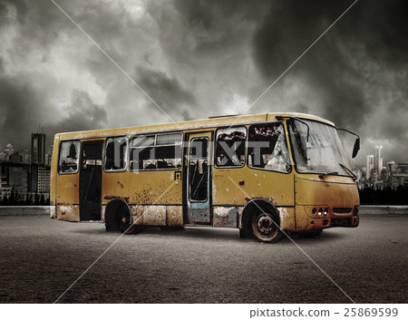 Broken bus on view of city in stormy sky Broken bus on view of city in stormy sky 25869599