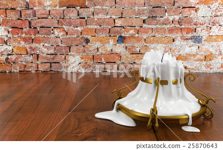 Melted candle and gold candle holder isolated  25870643
