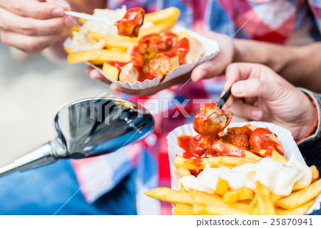 Currywurst and french fries on scooter Currywurst and french fries on scooter 25870941