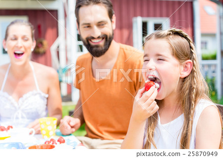 Family having coffee in garden Family having coffee in garden 25870949