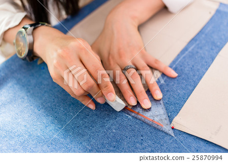 Detail of hands with scissors at tailor  25870994
