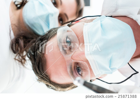 Dentist in treatment from patient point of view 25871388