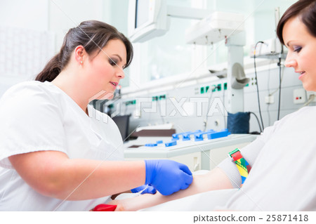 Nurse in hospital checking access at blood donor 25871418