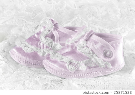 Pink baby booties on a lace background 25871528