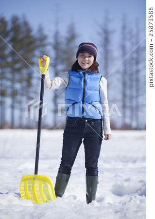 A woman snowing away A woman snowing away 25871588