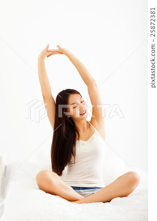 beautiful young asian woman stretching in bed beautiful young asian woman stretching in bed 25872381