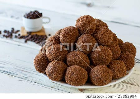 Brown candies on white plate. Brown candies on white plate. 25882994