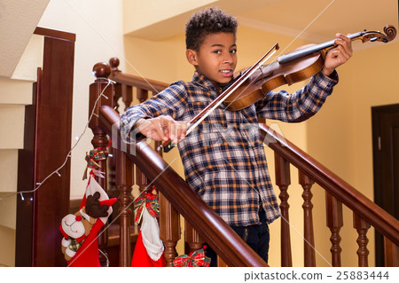Smiling afro kid plays violin. 25883444