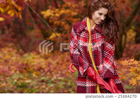 Autumn woman in autumn park with red umbrella 25884270