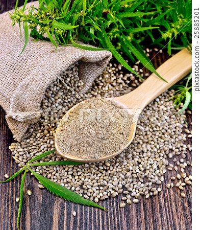 Flour hemp in spoon with leaf and bag on board 25885201