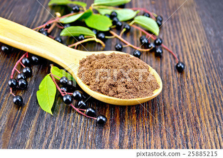 Flour bird cherry in spoon with berries 25885215