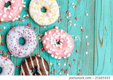 Donuts on colorful wooden background Donuts on colorful wooden background 25885935
