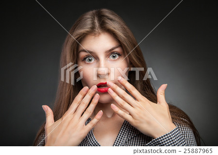 Surprised girl with wide opened eyes. 25887965