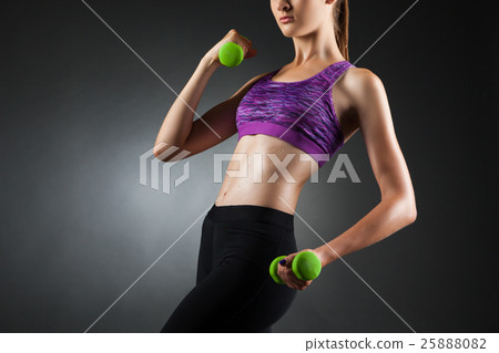 Beautiful anonymous woman doing biceps exercises. Beautiful anonymous woman doing biceps exercises. 25888082