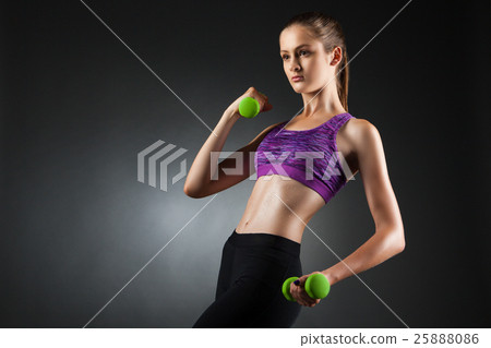 Beautiful woman doing biceps exercises. 25888086
