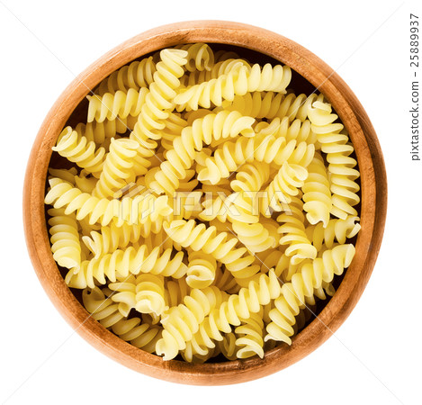 Girandole torsades pasta in wooden bowl over white 25889937