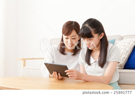 Parents enjoying tablets 25891777
