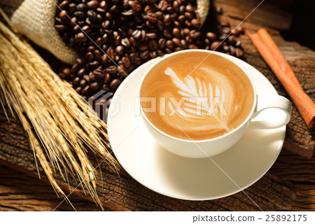 Cafe latte and coffee beans on wooden background Cafe latte and coffee beans on wooden background 25892175