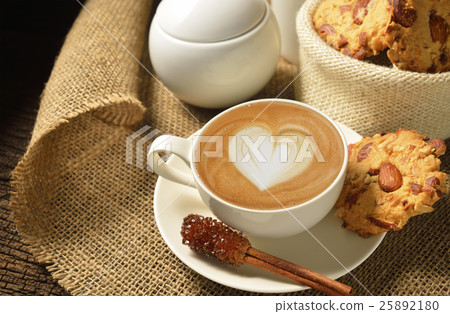 Cup of cafe latte and cookies on wooden background 25892180