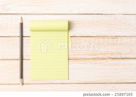 Green line paper with black pencil on wooden table 25897105