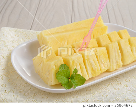Sliced of ripe pineapple on wooden background Sliced of ripe pineapple on wooden background 25904672