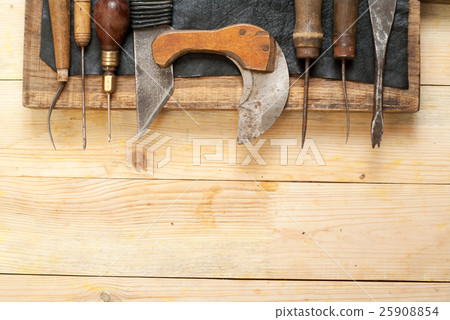 Leather craft tools on wooden background Leather craft tools on wooden background 25908854