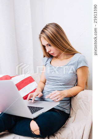 Teen using laptop at home Teen using laptop at home 25913390