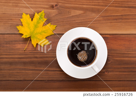Cup of coffee and yellow maple leaf. Cup of coffee and yellow maple leaf. 25916726