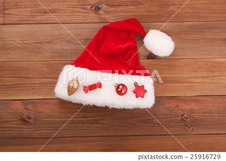 Santa hat Claus with toys on wooden background. Santa hat Claus with toys on wooden background. 25916729