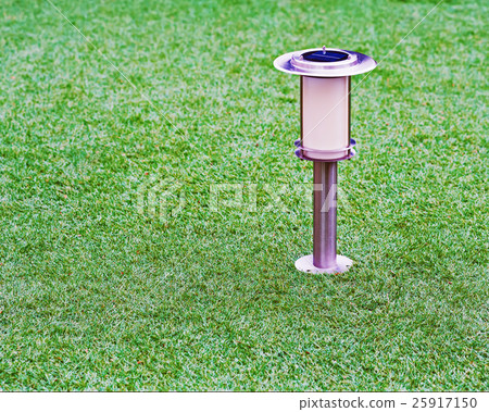 Solar-powered lamp on garden background. 25917150