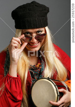 Woman in colorful clothes black hat and sunglasses Woman in colorful clothes black hat and sunglasses 25917239