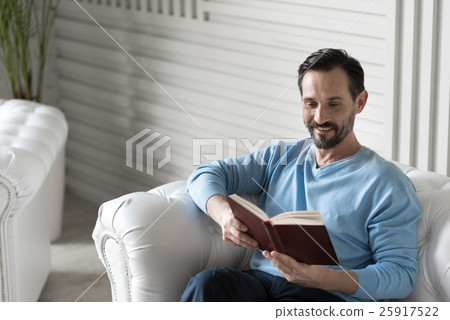 Happy intelligent man reading a book Happy intelligent man reading a book 25917522