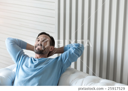 Happy delighted man holding his hands behind the Happy delighted man holding his hands behind the 25917529