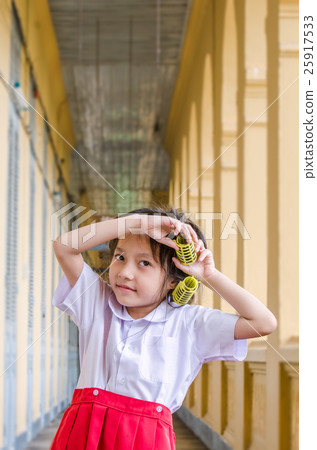Little schoolgirl in uniform with hair curlers Little schoolgirl in uniform with hair curlers 25917533