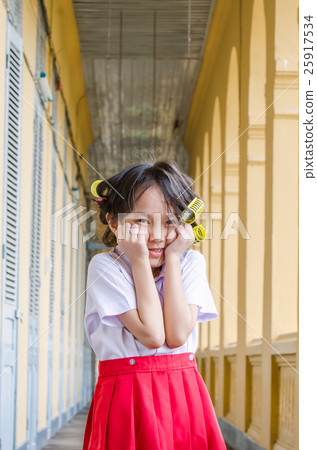 Little schoolgirl in uniform with hair curlers Little schoolgirl in uniform with hair curlers 25917534