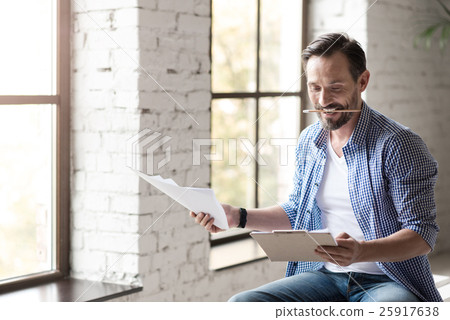 Attractive positive man clenching a pencil in his Attractive positive man clenching a pencil in his 25917638