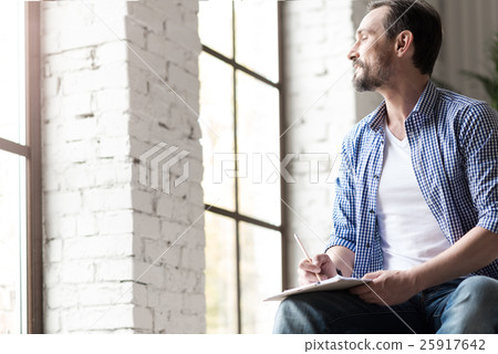 Good looking talented man drawing a picture Good looking talented man drawing a picture 25917642