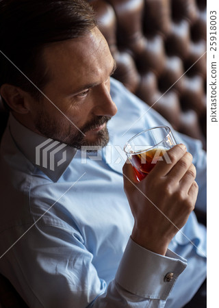 Confident brutal man drinking whisky 25918003