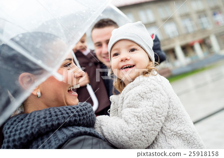 Young family with two daughters under the 25918158