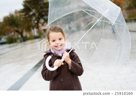 Little girl under the transparent umbrella outside Little girl under the transparent umbrella outside 25918160