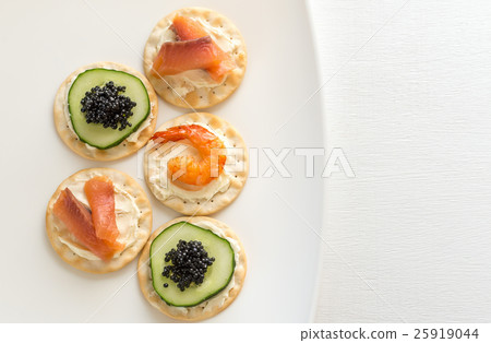 Canape with seafood on the plate 25919044