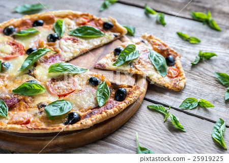 Cut pizza on the wooden board 25919225