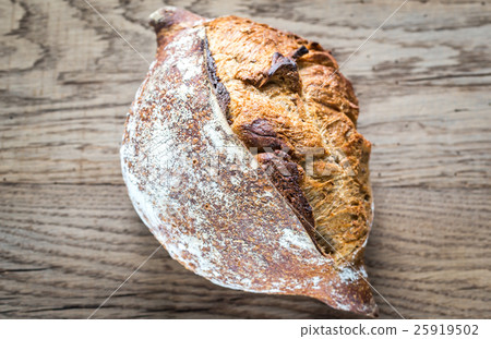Wholegrain bread on the wooden background 25919502