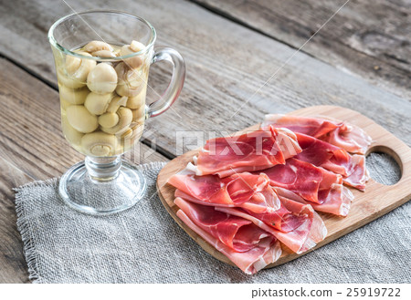 Slices of jamon on the wooden board Slices of jamon on the wooden board 25919722