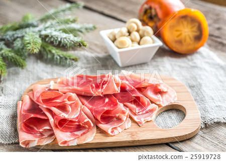 Slices of jamon on the wooden board Slices of jamon on the wooden board 25919728